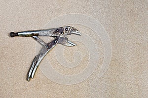 Old locking pliers on wooden background
