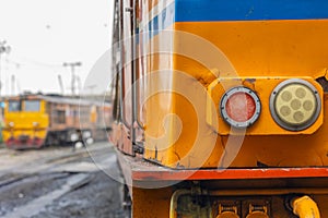 old locomotive diesel train in the rail track close up front headlight