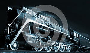 Old locomotive is moving in the night photo