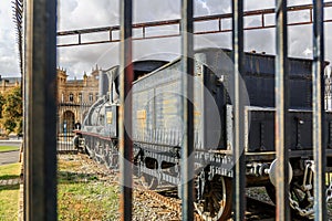 Old locomotive of a vintage train next to a station