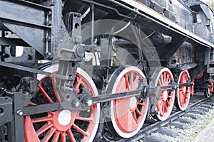 Old locomotive wheels close up.