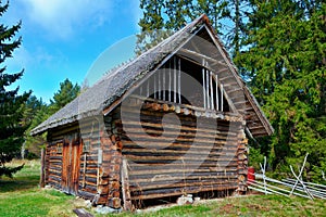 Old log barn with a thatched roof