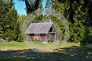 Old log barn with a thatched roof