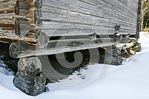 An old log building built on top of stones