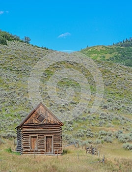 Old log cabin, abandoned in the country hillside of Rocky Mountains in Colorado