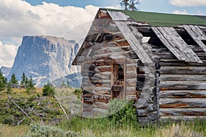 Old log cabin and Flat Top Mountain, Wyoming photo