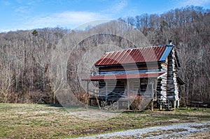 An old log cabin sitting amidst winter`s desolate landscape, southeastern Tennessee