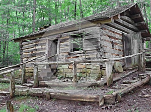 Old Log house on hill in woods.