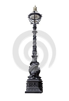 Old London dolphin lamp post isolated on white