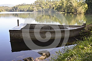 Old and lonely  wooden boat anchored