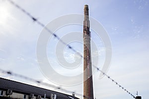 Old long brick chimney against blue sky,old factory industrie