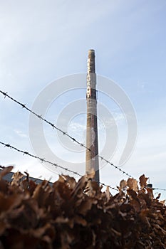 Old long brick chimney with the words Restaurant against blue sky,old factory industrie