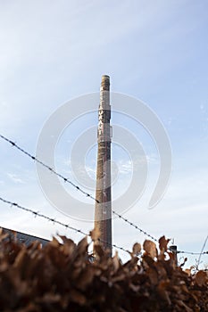 Old long brick chimney with the words Restaurant against blue sky,old factory industrie