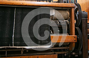 Old loom, spinning machine, rows of white and colored cotton threads