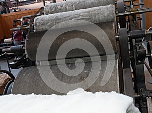 Old loom, spinning machine, rows of white and colored cotton threads