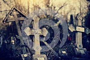 Old lop-sided sepulchral crosses on the thrown graves at the cemetery.