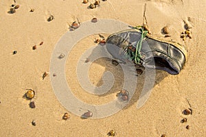 Old, lost shoe on a beach