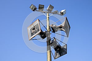 Old loudspeakers against blue sky