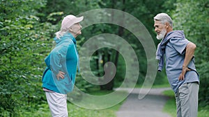 Old love couple sport exercise. Elderly fun people training workout forest park.