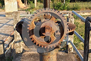 Old machine with cogs and gears.gear for open water gates near river Thailand