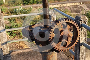 Old machine with cogs and gears.gear for open water gates near river Thailand
