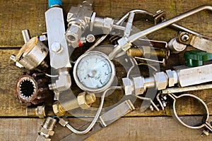 Old machine parts in machinery shop on wooden background