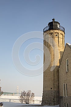 Old Mackinac Point Lighthouse and Mackinac Bridge on frozen Lak