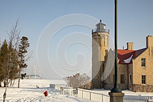 Old Mackinac Point Lighthouse and Mackinac Bridge on frozen Straits of Mackinac, Mackinac City, Michigan in winter