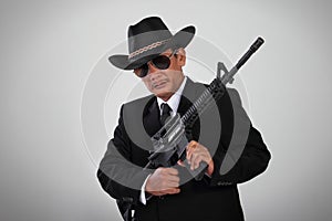 Old mafia and his assault weapon photo