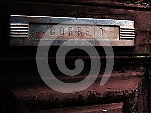 Old mail slot in old door photo