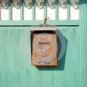 Old Mailbox on a green gate
