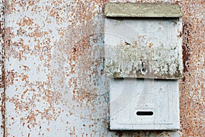 Old mailbox for paper letters. Rusted metal blue wall