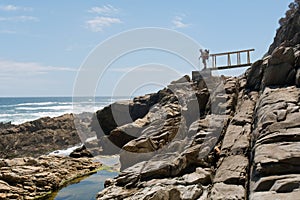 Old male backpacker looks at sea photo