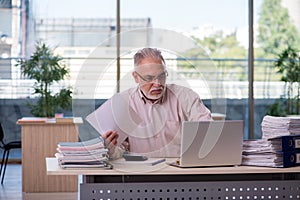 Old male bookkeeper in budget planning concept