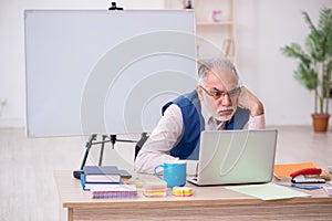 Old male designer working in the office