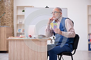 Old male designer working in the office