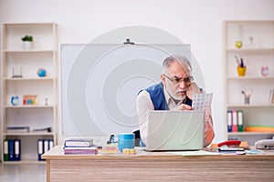 Old male designer working in the office