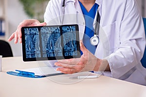 Old male doctor radiologist in telehealth concept