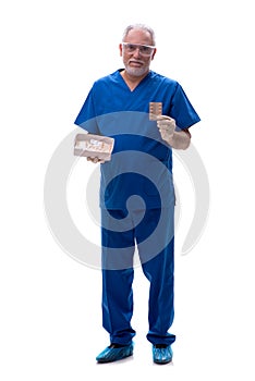 Old male doctor suggesting pills isolated on white