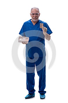 Old male doctor suggesting pills isolated on white