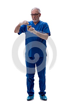 Old male doctor suggesting pills isolated on white