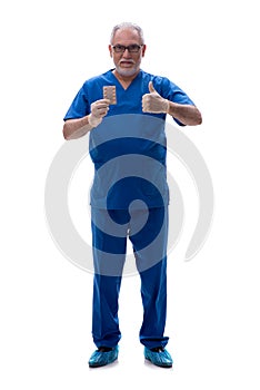 Old male doctor suggesting pills isolated on white