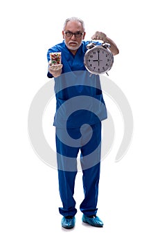 Old male doctor in time management concept