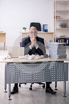 Old male employee in brainstorming concept