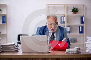 Old male employee feeling bad at workplace