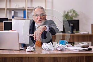 Old male employee in paper recycling concept