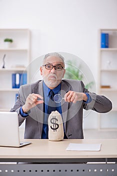 Old male employee in remuneration concept