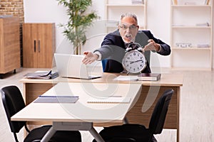 Old male employer in time management concept