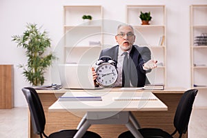 Old male employer in time management concept