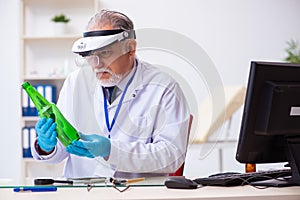 Old male expert criminologist working in the lab for evidence